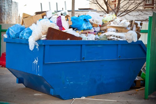 Construction site with builders managing waste removal