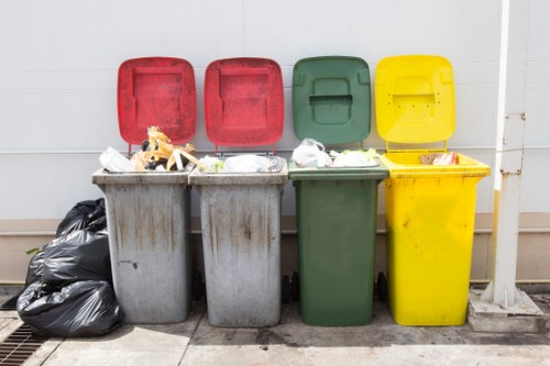 Construction workers loading waste into a skip